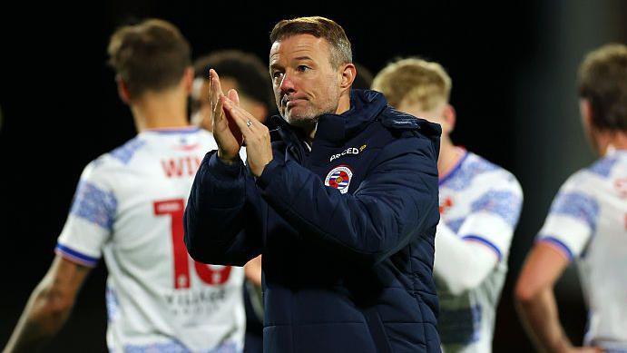 Reading boss Noel Hunt applauds the fans after a game.