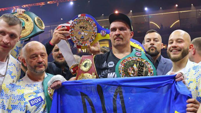 Oleksandr Usyk celebrating with his four belts after his victory over Tydon Fury