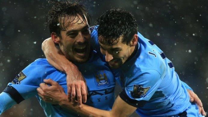 David Silva celebrates with Jesus Navas after scoring Manchester City's third goal