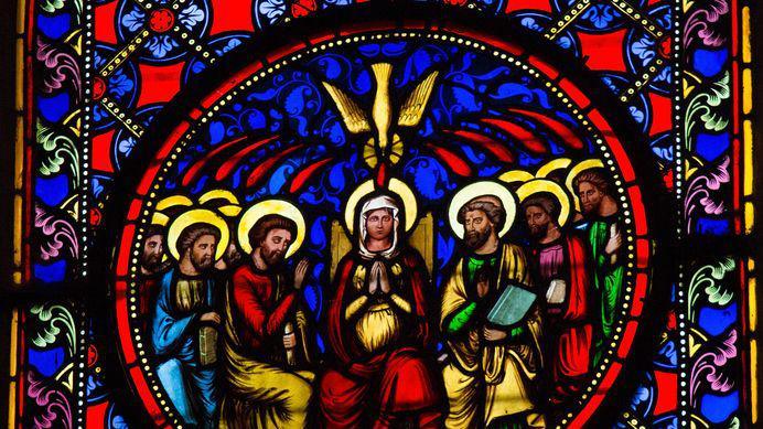A stained glass window depicting Pentecost.