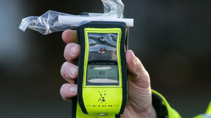 Breathalyser device in hand of police officer