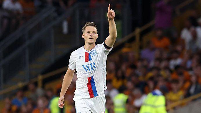 Sean McLoughlin raises his right arm to celebrate scoring for Blackburn Rovers