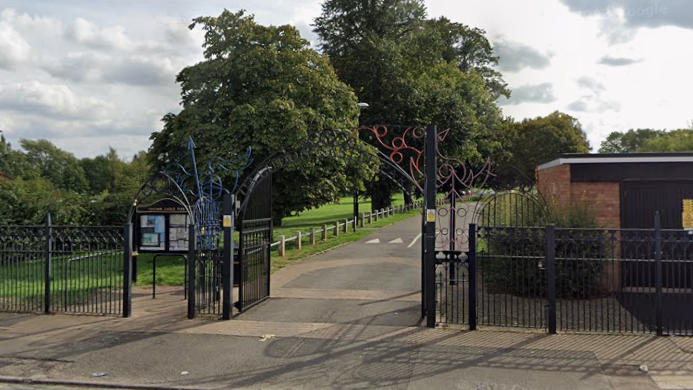 The Caludon Castle Park entrance from Farren Road with large black gates.