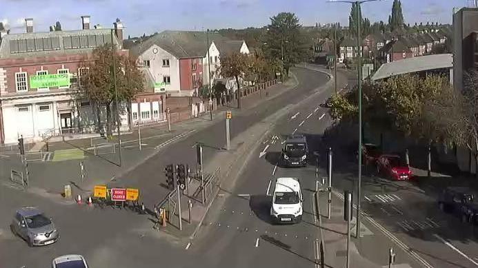 A CCTV image of the junction between Valley Road and Nottingham Road, showing both carriageways virtually empty and the two lanes leading away from the camera sealed with police signage