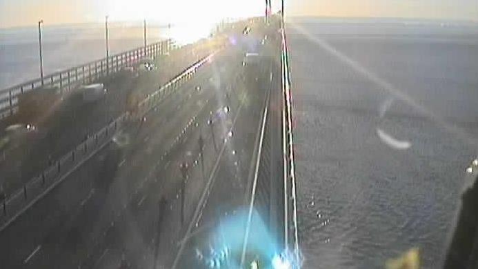 A traffic camera image of the M4 Prince of Wales Bridge. The sun is rising in the picture, with traffic seen on the left hand side of the bridge. 