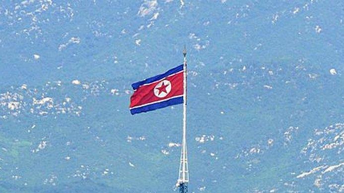 A North Korean flag flutters in the propaganda village of Gijeongdong