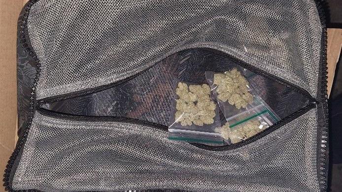 Green drugs in small plastic bags in a bigger grey bag