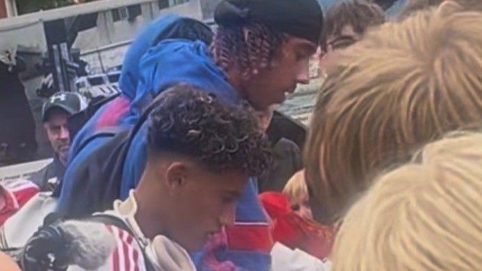 Manchester United's JJ Gabriel and Leny Yoro signing autographs after arriving in Norway on Thursday