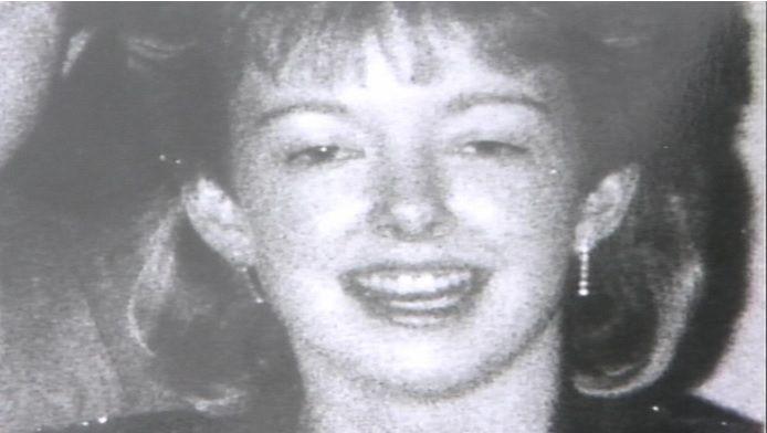 A black and white photograph of Diane Sindall, who has her hair cut into a fringe, smiling at the camera.