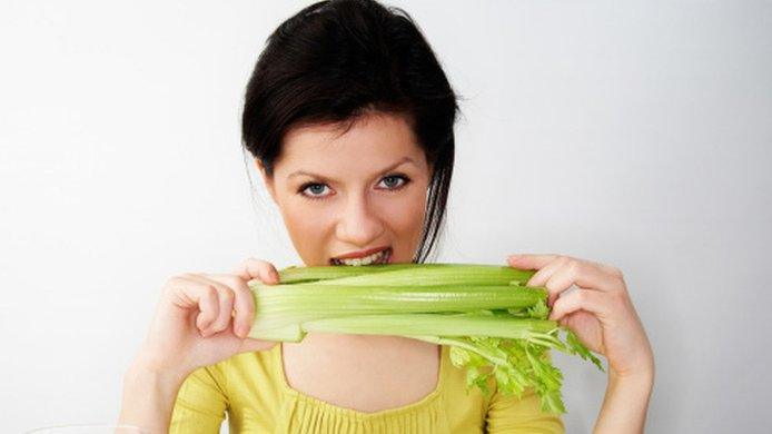 Woman eating celery