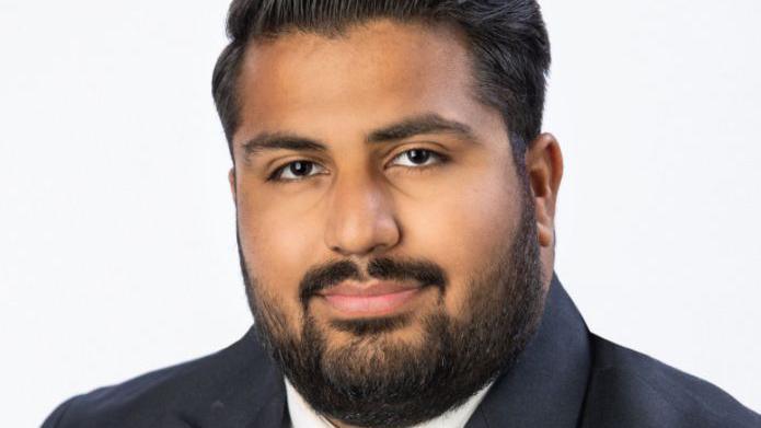 Head shot of Tamworth's new owner Abdullah Ashraf. He is wearing a dark suit jacket and white shirt.