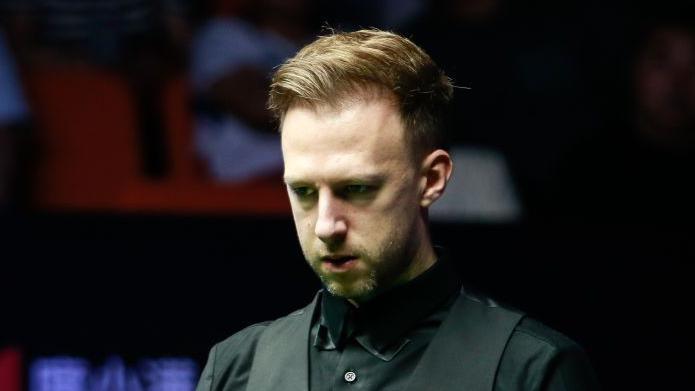 Judd Trump lines up a shot in snooker