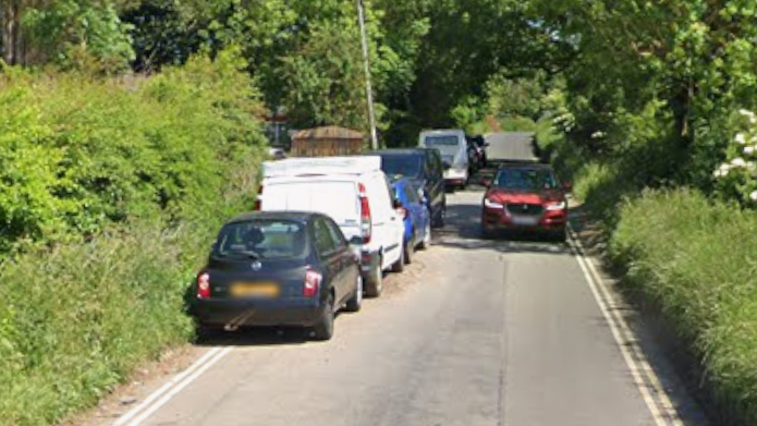 Pettiwell, in Garsington, is a single track road, but there are various cars all parked on double yellows on the left hand side of the street.