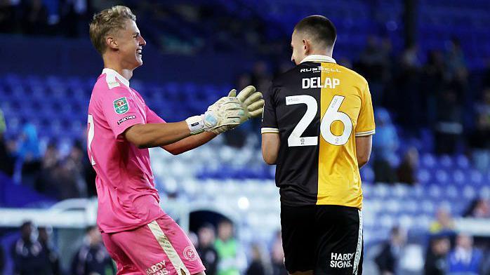 Burton's Fin Delap celebrates with keeper Kamil Dudek after Burton's win on penalties