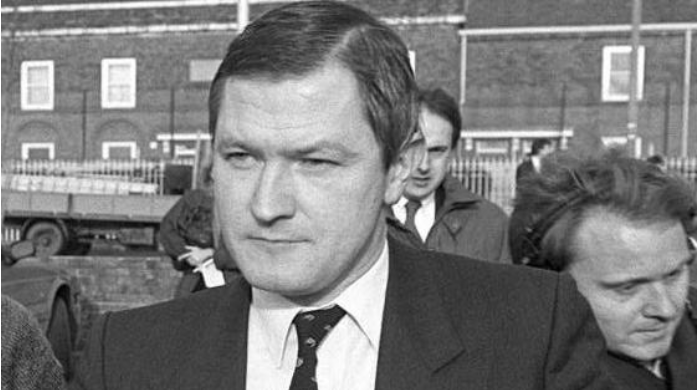 Pat Finucane walking from court in black and white