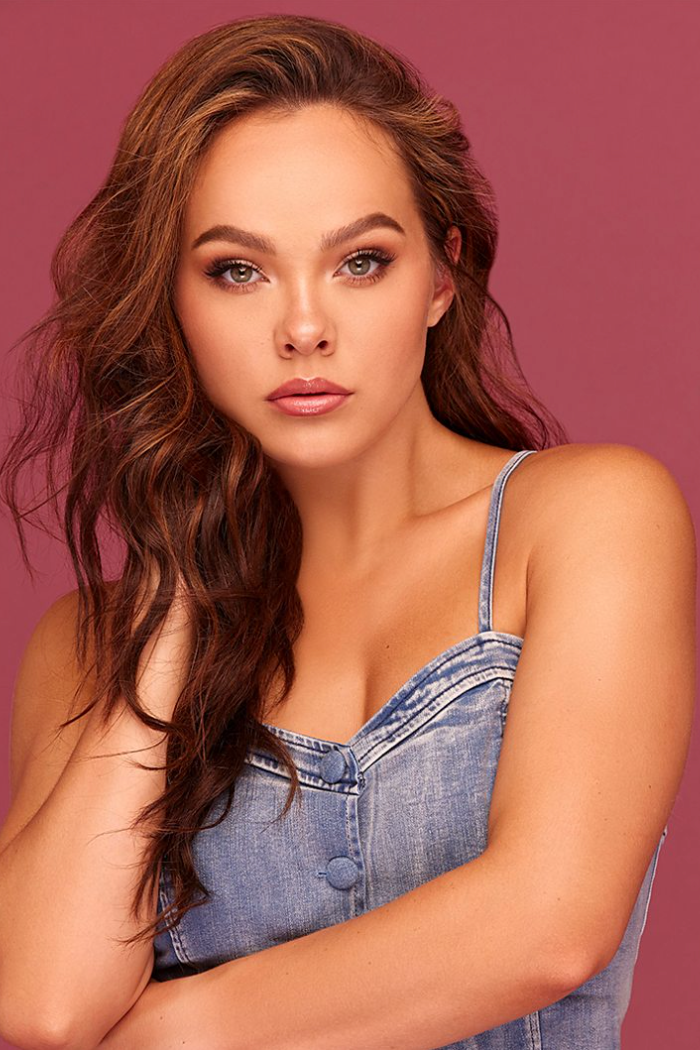 Headshot of Alex against a red coloured background