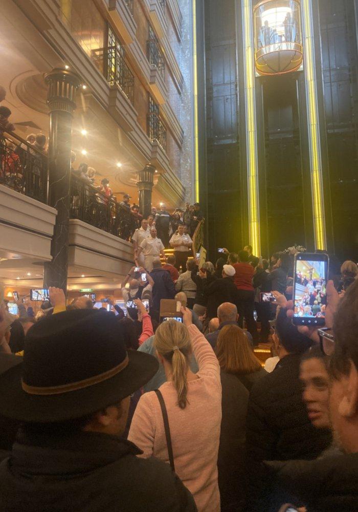 Passengers crowd around a stairway on the Norwegian Spirit