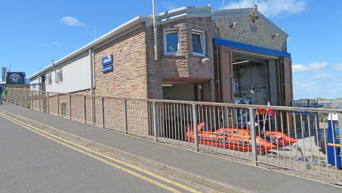 The outside of the Seahouses boathouse with the inshore rescue boat parked outside 