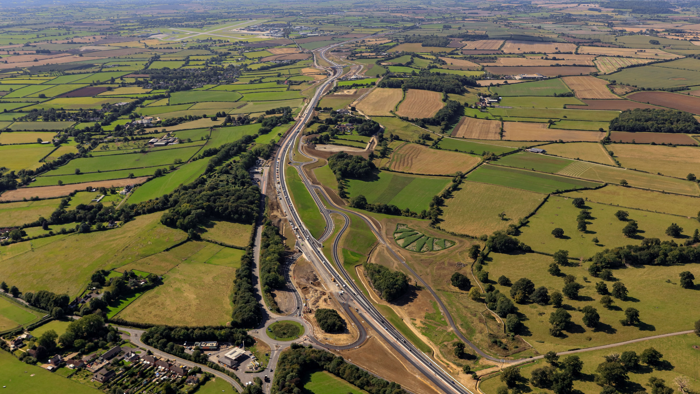 An aerial shot of the A303 between Sparkford and Ilchester.  There are green fields and trees either side of the road.