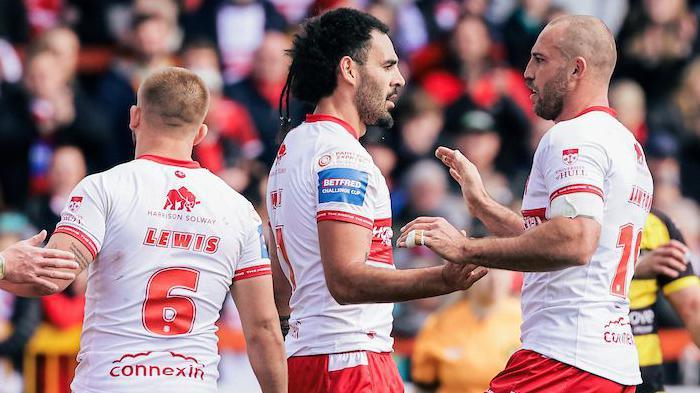 Hull Kingston Rovers player Tyrone May, centre in white shirt and red shorts, is congratulated by team-mate Karl Lawton (right) with Mikey Lewis also approaching him (left), after he scored a try against York Knights.