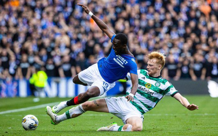 Celtic's Liam Scales tackles Rangers' Abdallah Sima