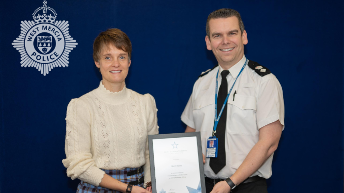 Mairi Kerin holds a certificated after she is presented with the award by Ch Supt Edd Williams.