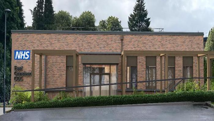 A digital generated image of a single-storey building that has exposed brick on the outside. There is an NHS logo on the left of the building.