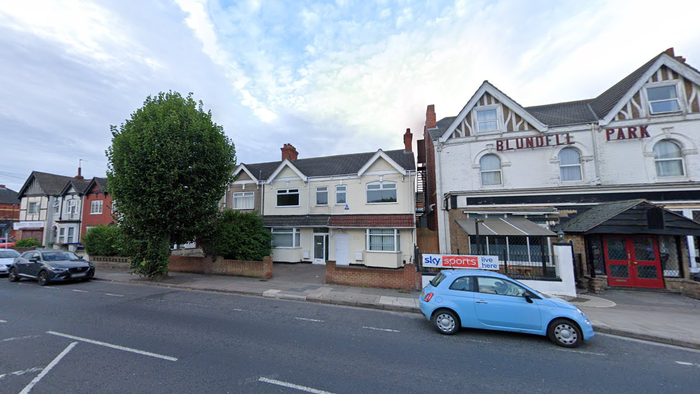 Google street view of the former Blundell Park Surgery. A pale yellow property with one floor next to Blundell Park Hotel and other properties on the other side