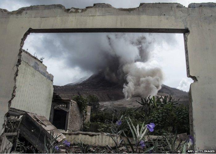 This picture taken in Karo on June 14, 2015 shows Mounts Sinabung spewing volcanic ash