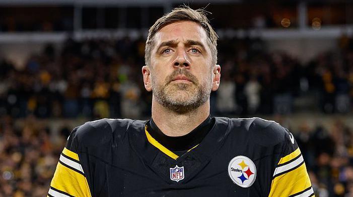 Aaron Rodgers looks on during the national anthem before his Pittsburgh Steelers team loses to the Houston Texans in the NFL play-offs in 2026