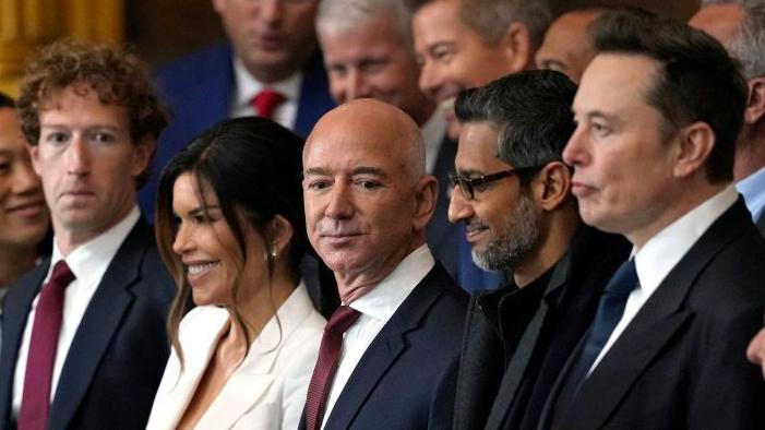 From left to right: Meta chief executive Mark Zuckerberg, American journalist Lauren Sánchez, Amazon chief executive Jeff Bezos, Alphabet chief executive Sundar Pichai, and Tesla chief executive Elon Musk. All are stood watching US President Donald Trump's inauguration in January 2025.