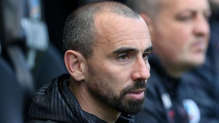 Leon Britton watches a game 