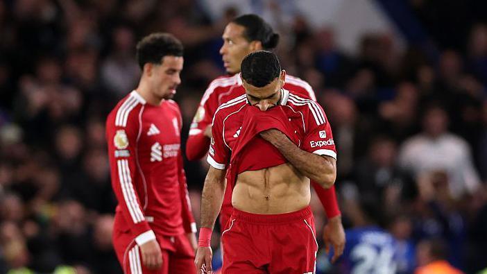 Liverpool players look disappointed after their loss to Chelsea