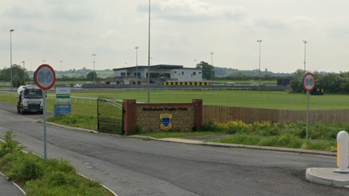 A view of the entrance to Melksham Rugby Club with Oakfield Stadium behind it