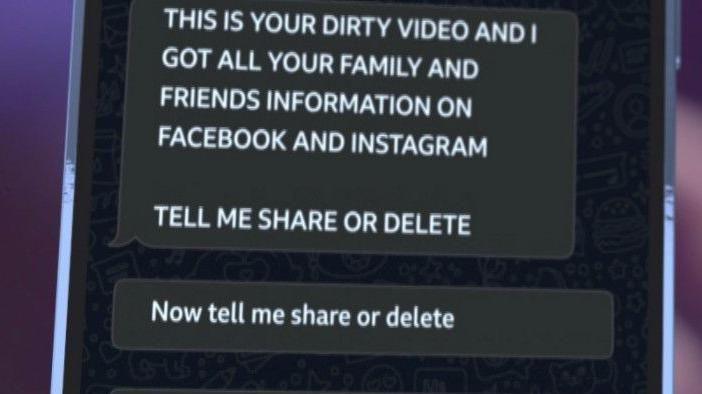A close-up of a screen showing threatening messages claiming to have a “dirty video” and information about family and friends on Facebook and Instagram, followed by a demand asking whether the material should be shared or deleted.
