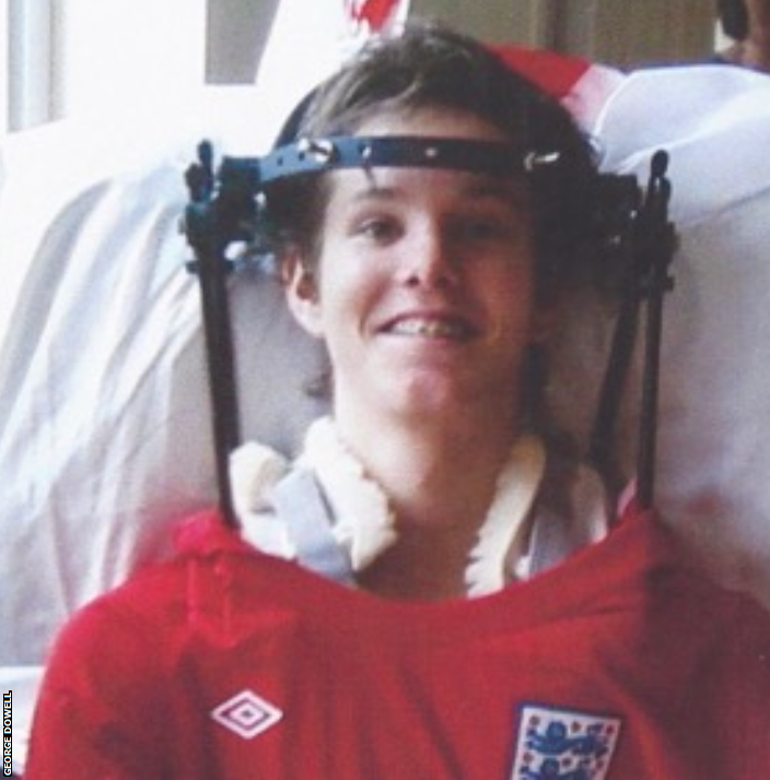 Worthing owner George Dowell in an England top at a spinal treatment centre in Salisbury