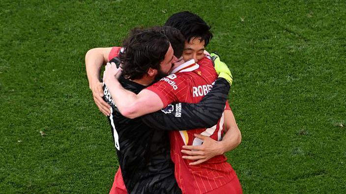 Andy Robertson, Alisson Becker and Wataru Endo celebrate at the final whistle