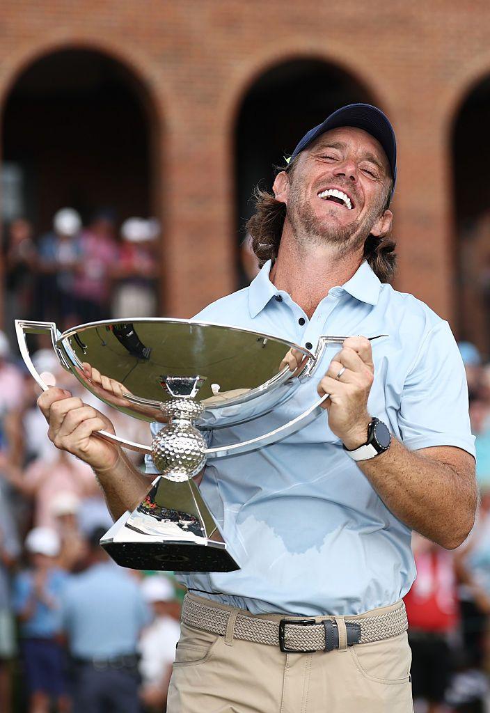 England's Tommy Fleetwood celebrates with the Fedex Cup trophy after winning the final round of the TOUR Championship 2025 at East Lake Golf Club in Atlanta, Georgia. Photo by Jared C. Tilton