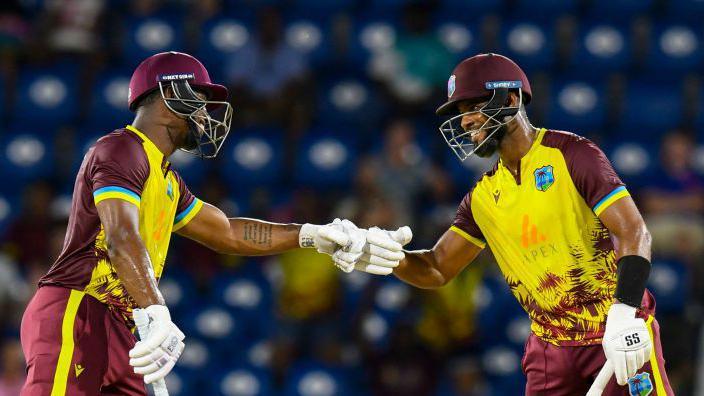 Evin Lewis and Shai Hope bump fists during their partnership of 136 v England