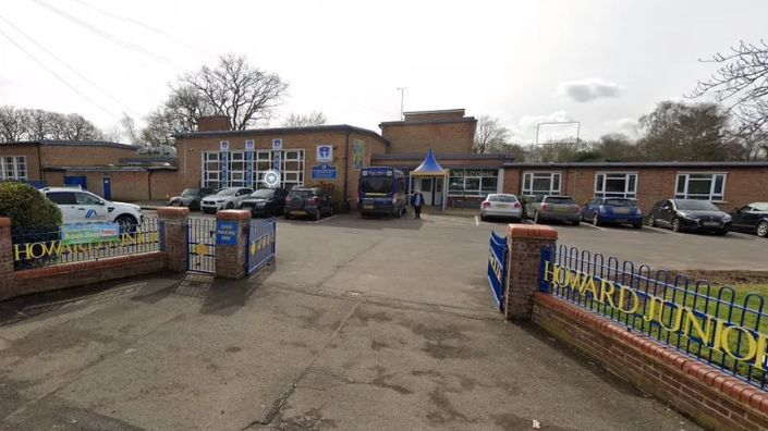 View of Howard Junior School gates, car park and main entrance