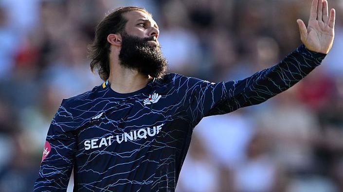 Moeen Ali, in his delivery stride, about to bowl for Yorkshire against Nottinghamshire