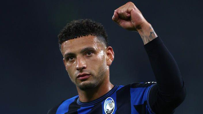 Ben Godfrey salutes the Atalanta fans after the team's Champions League win over Shakhtar Donetsk in Gelsenkirchen