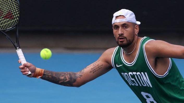 Nick Kyrgios hits a forehand return in practice at the Australian Open