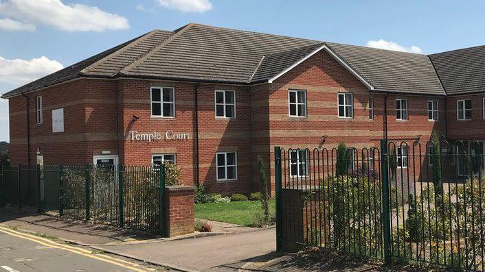 Brick care home with "Temple Court" sign