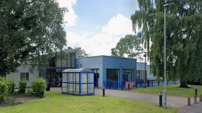 Woolston Neighbourhood Hub features a leisure centre and library. It is a collection of panelled modern buildings in a leafy, green setting.