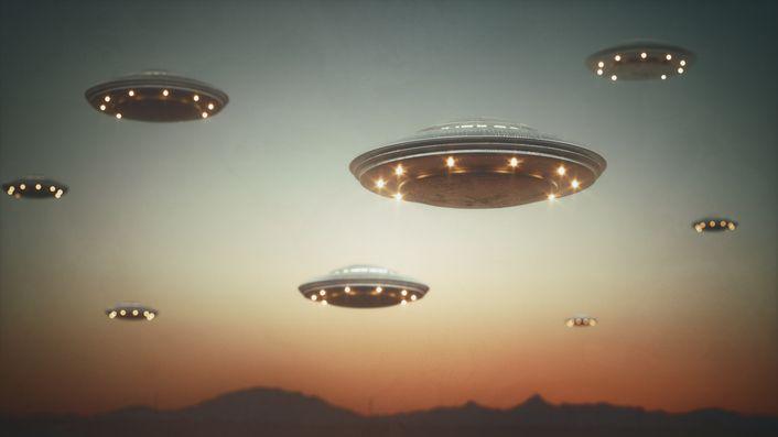 A number of flying saucers in the sky