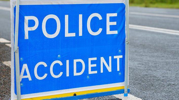 Blue police accident sign with white writing