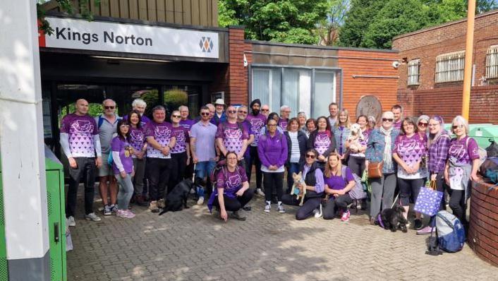 Walkers in RoadPiece t-shirts outside a station