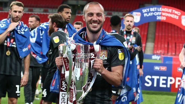 Michael Harriman holding the Football League Two play-off trophy