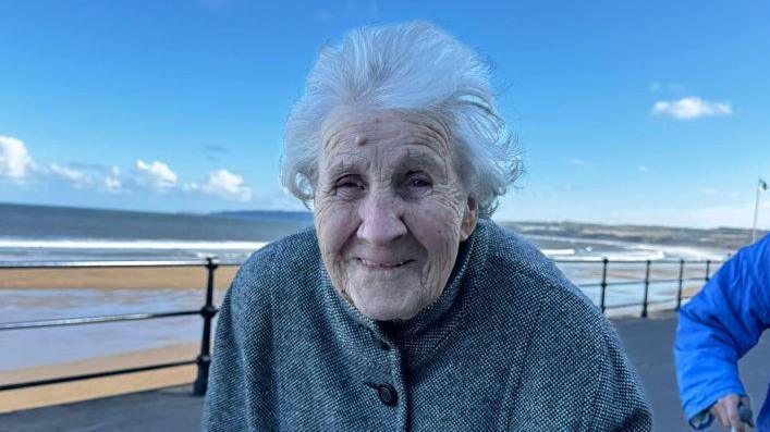 IMage if Hilda along the seafront in Filey. 